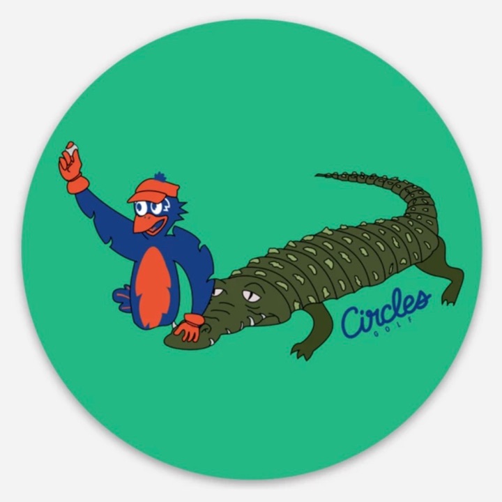 Circles Golf Mascot Getting Golf Ball From Alligator Sticker